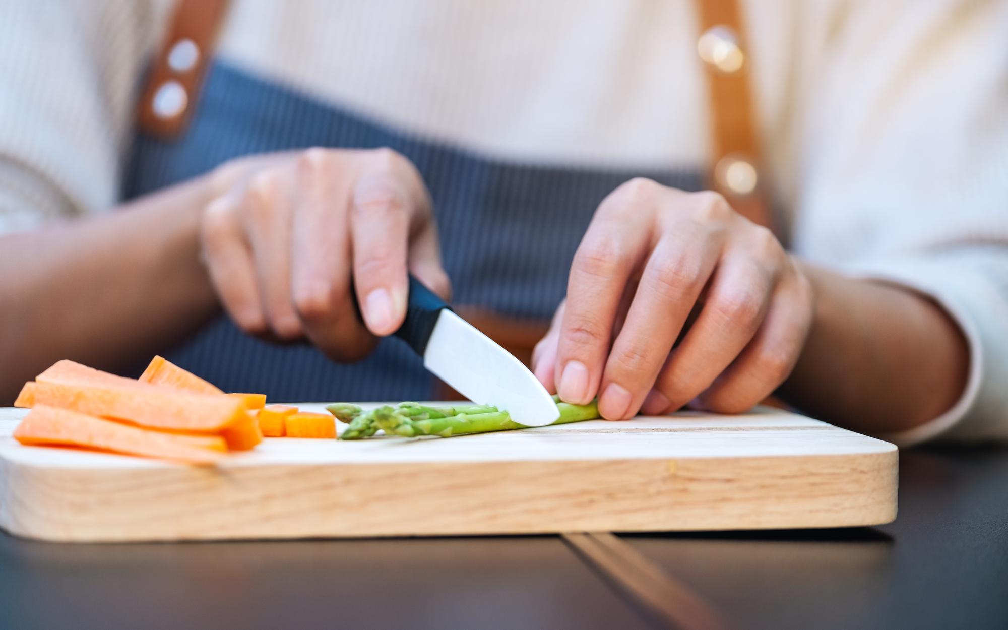 Participant slicing a vegetable with modern knife
